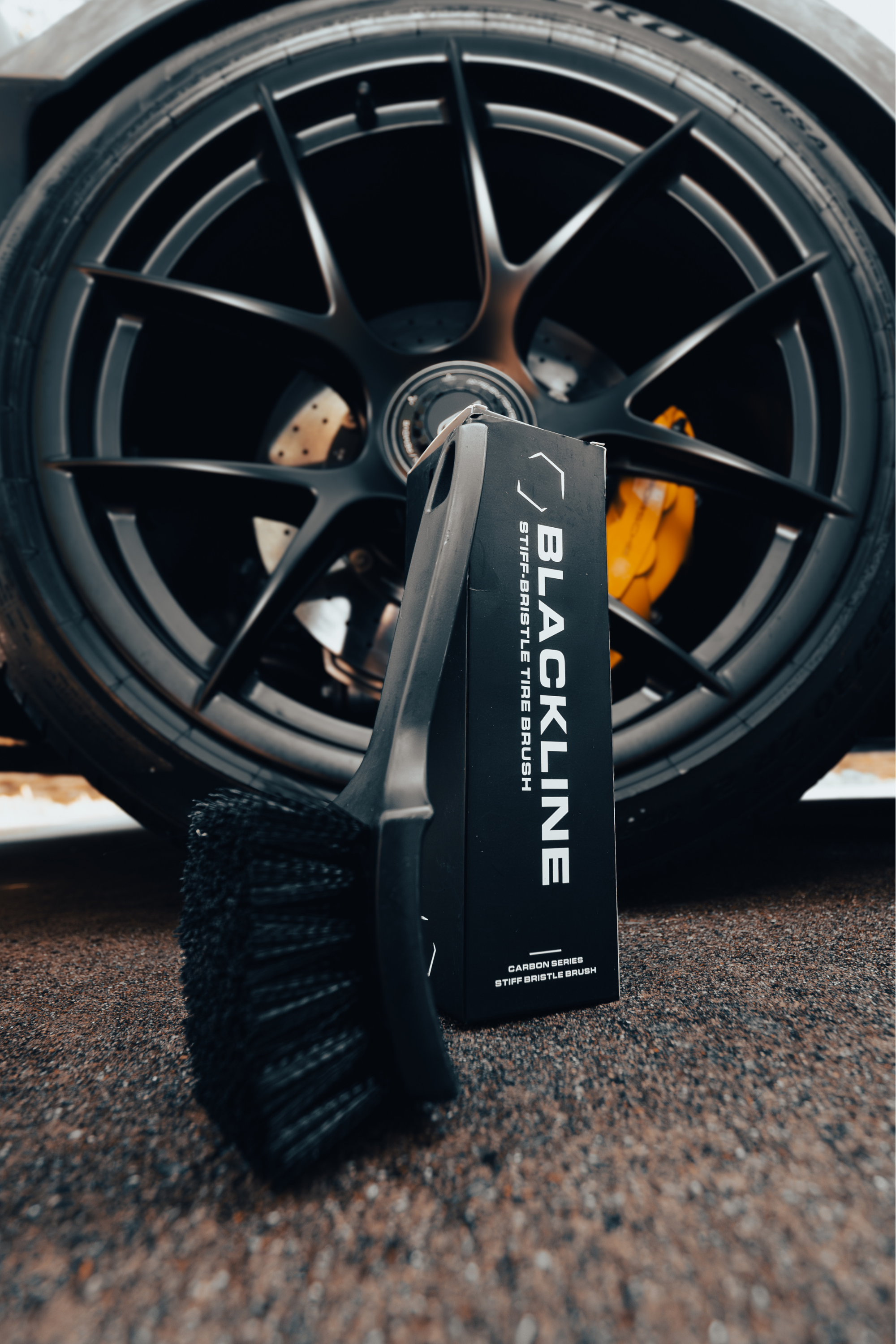 Blackline Car Care BLACKLINE® STIFF BRISTLE TIRE BRUSH in use - professional detailing application