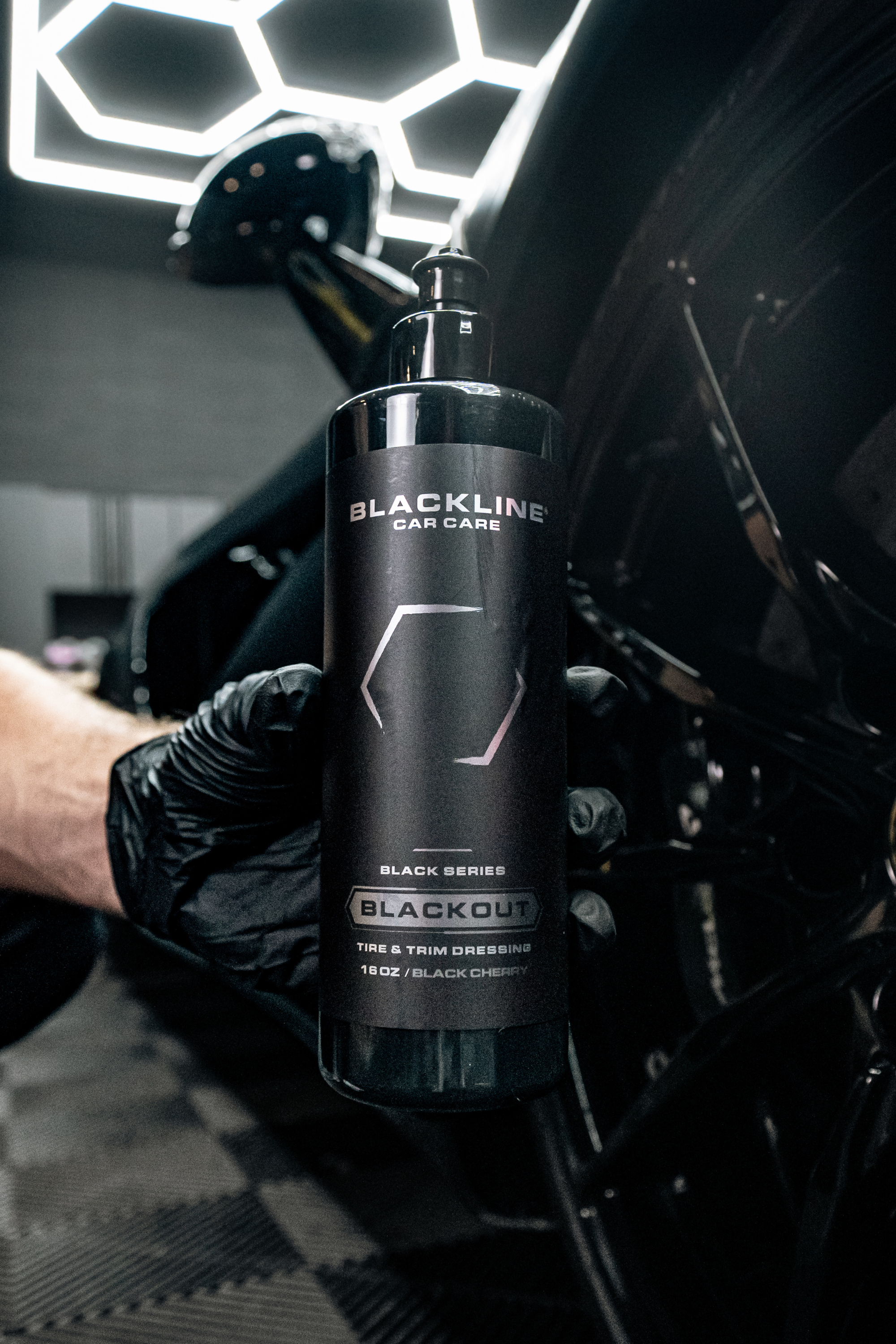 Blackline Car Care BLACKLINE® BLACKOUT TRIM & TIRE DRESSING in use - professional detailing application