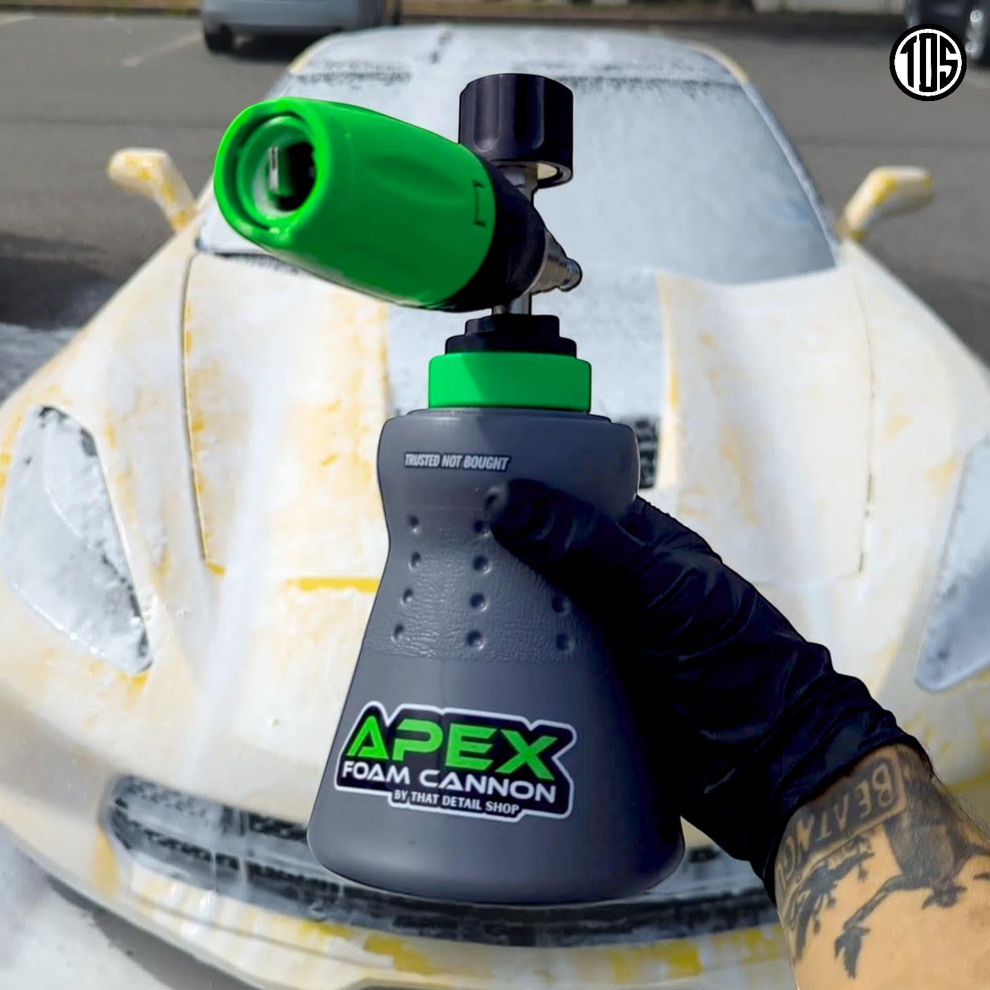 TDS Foam Cannon Apex producing thick snow foam on a black SUV with ApexBand grip band