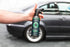 Armour Detail Supply PILOT Interior Detailer bottle held beside a car.