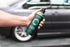 Armour Detail Supply SHAMPOO+ bottle held beside a car.