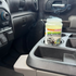 That Detail Shop Bio-Bombs vehicle deodorization kit activating in a car cup holder with visible vapor