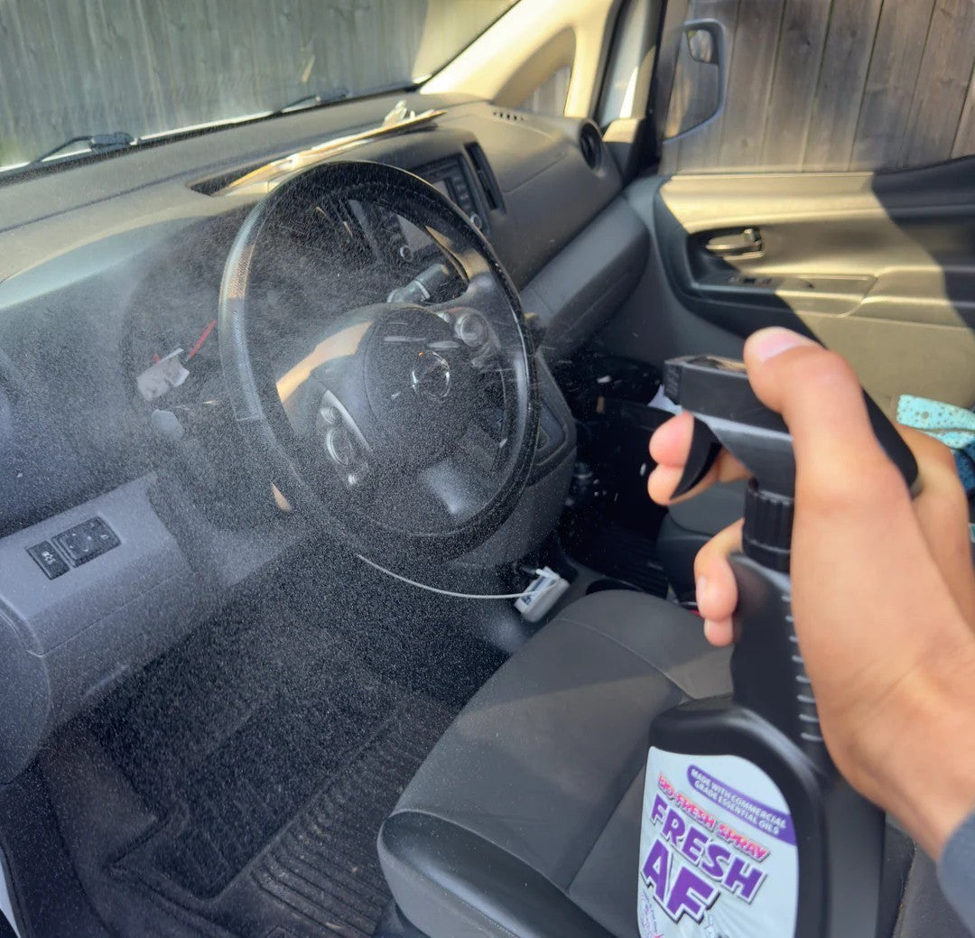 That Detail Shop Bio-Bombs Fresh AF air freshener spray being misted into a clean car interior.