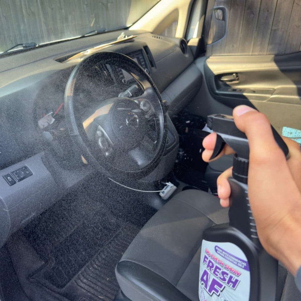 That Detail Shop Bio-Bombs Fresh AF air freshener spray being misted into a clean car interior.