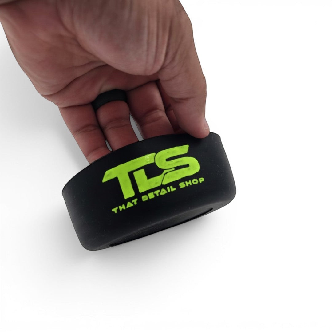 That Detail Shop TDS Welly black silicone bumper with lime green logo held in a hand for foam cannon protection