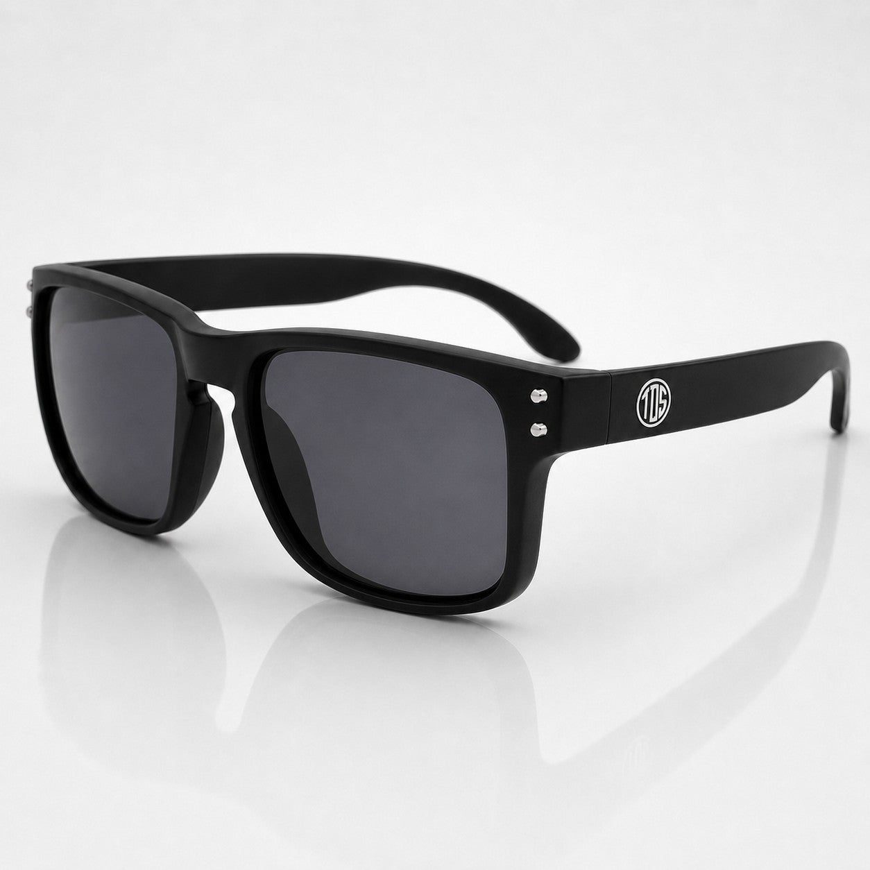 That Detail Shop matte black polarized sunglasses with a classic square frame and subtle TDS logo on the temple.