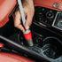 That Detail Shop detailing brush with red and grey handle cleaning car interior console.