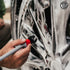 That Detail Shop exterior brush cleaning a black car wheel with foam.