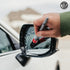 That Detail Shop exterior cleaning brush with red bristles cleaning a wet car mirror.