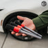 That Detail Shop exterior detailing brushes with black bristles and grey/red handles held in a hand.