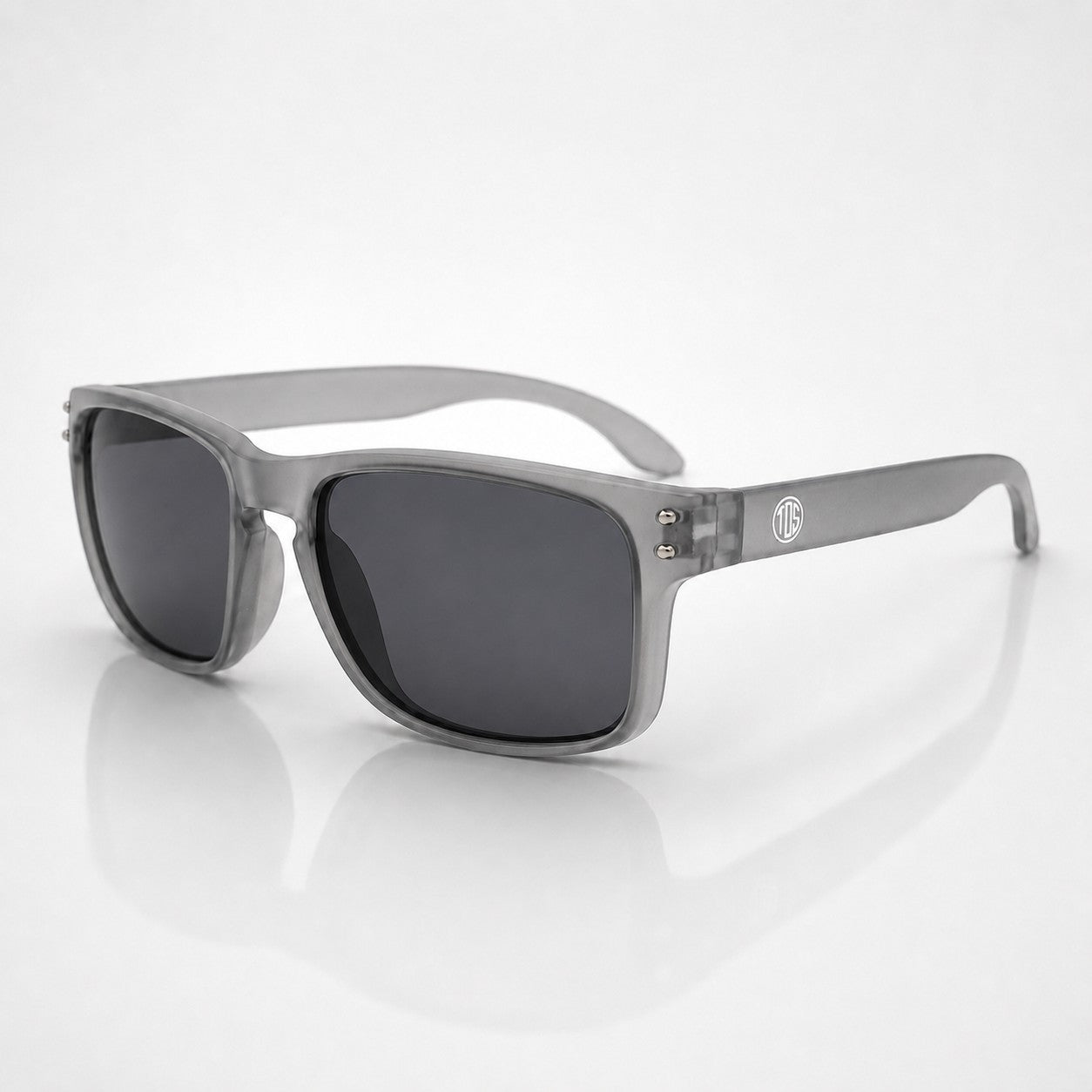That Detail Shop Frost Gray polarized sunglasses with a square frame and subtle temple logo on a white background.