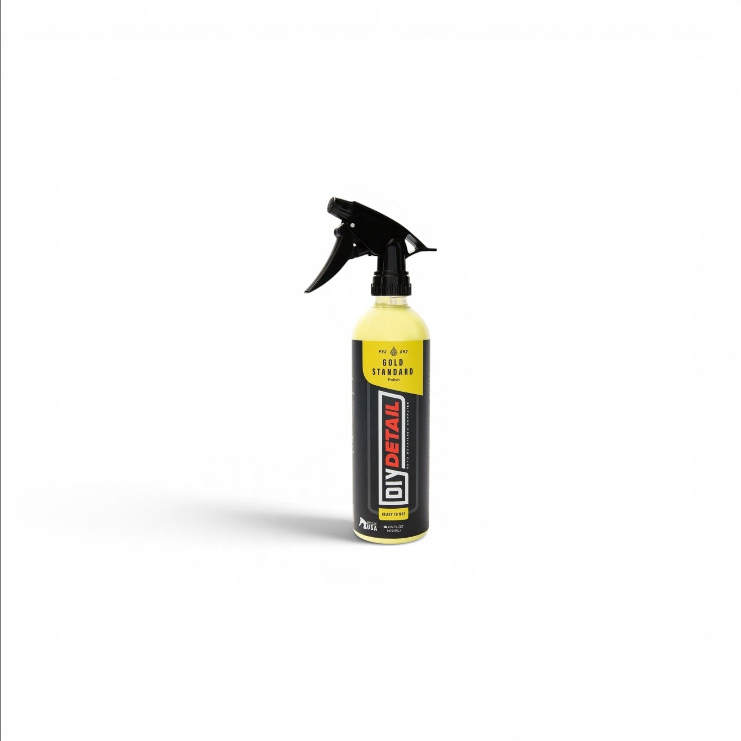 That Detail Shop Gold Standard Polish spray bottle, yellow liquid, black trigger spray, for machine polishing and swirl removal.