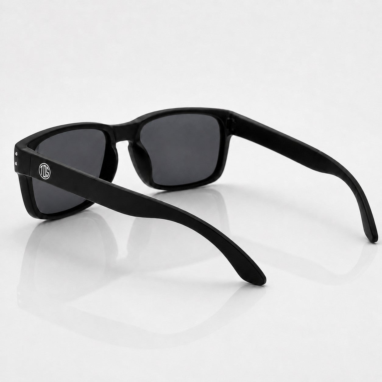 That Detail Shop matte black polarized sunglasses with a classic square frame and subtle TDS logo on the temple.