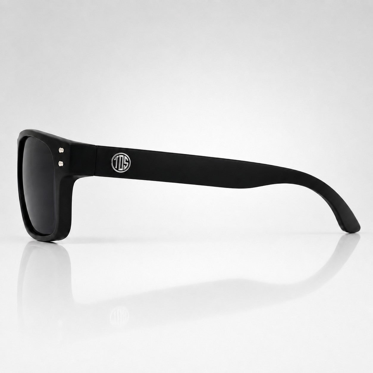 That Detail Shop matte black polarized sunglasses with a square frame and subtle TDS logo on the temple side view