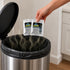 That Detail Shop Odor Control Granule Sachets being placed into a trash can with smoke effect.