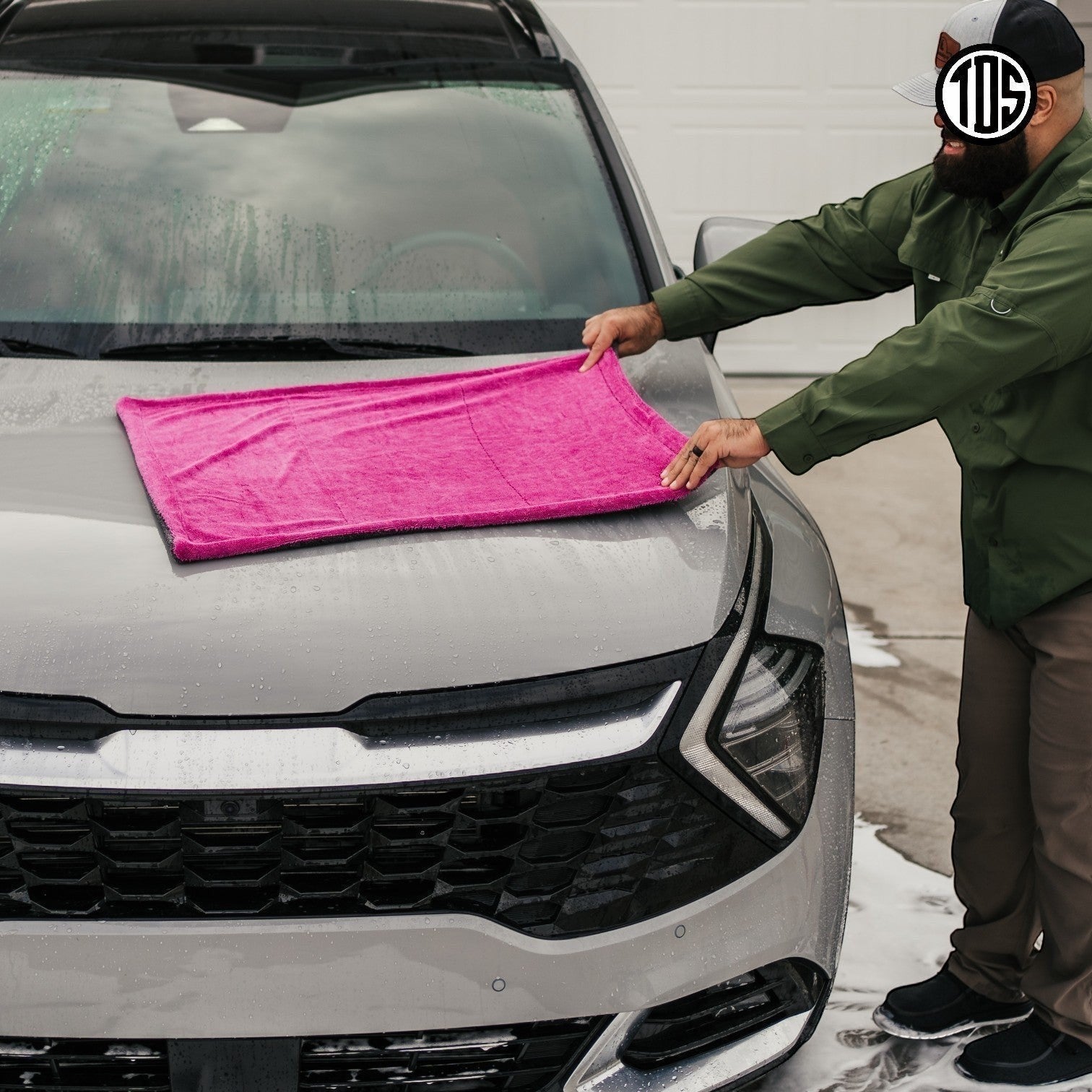 That Detail Shop pink and gray 1400 GSM microfiber drying towel on a car hood