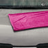 That Detail Shop pink and gray 1400 GSM microfiber drying towel with twisted loops on a wet car hood.
