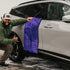 That Detail Shop purple 1600 GSM dual twisted-loop microfiber drying towel on a car.