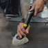 That Detail Shop professional using a steam cleaner with a triangular microfiber attachment on a car floor mat