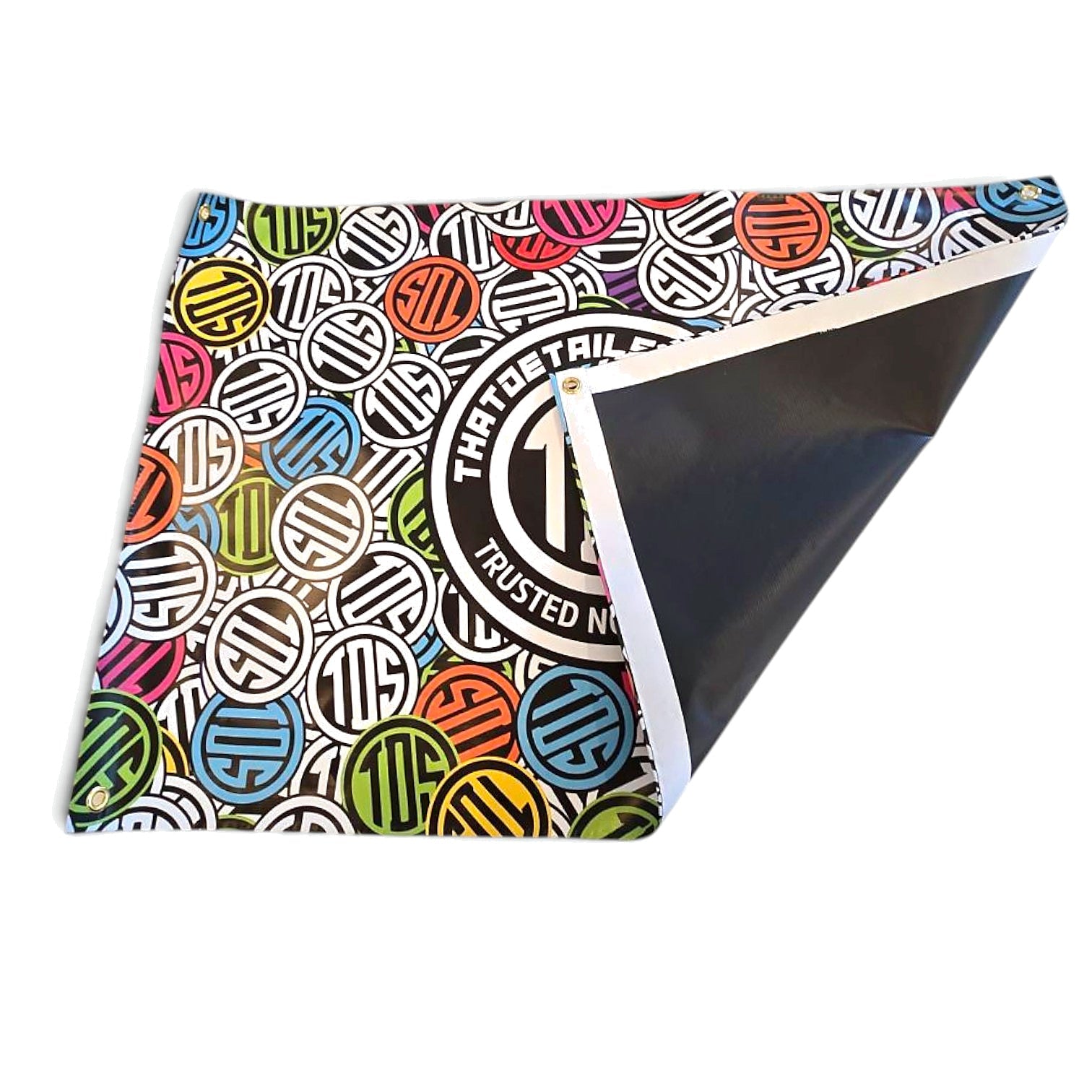 That Detail Shop Sticker Bomb PVC banner with multicolor logo pattern and corner grommets for garage or shop display.