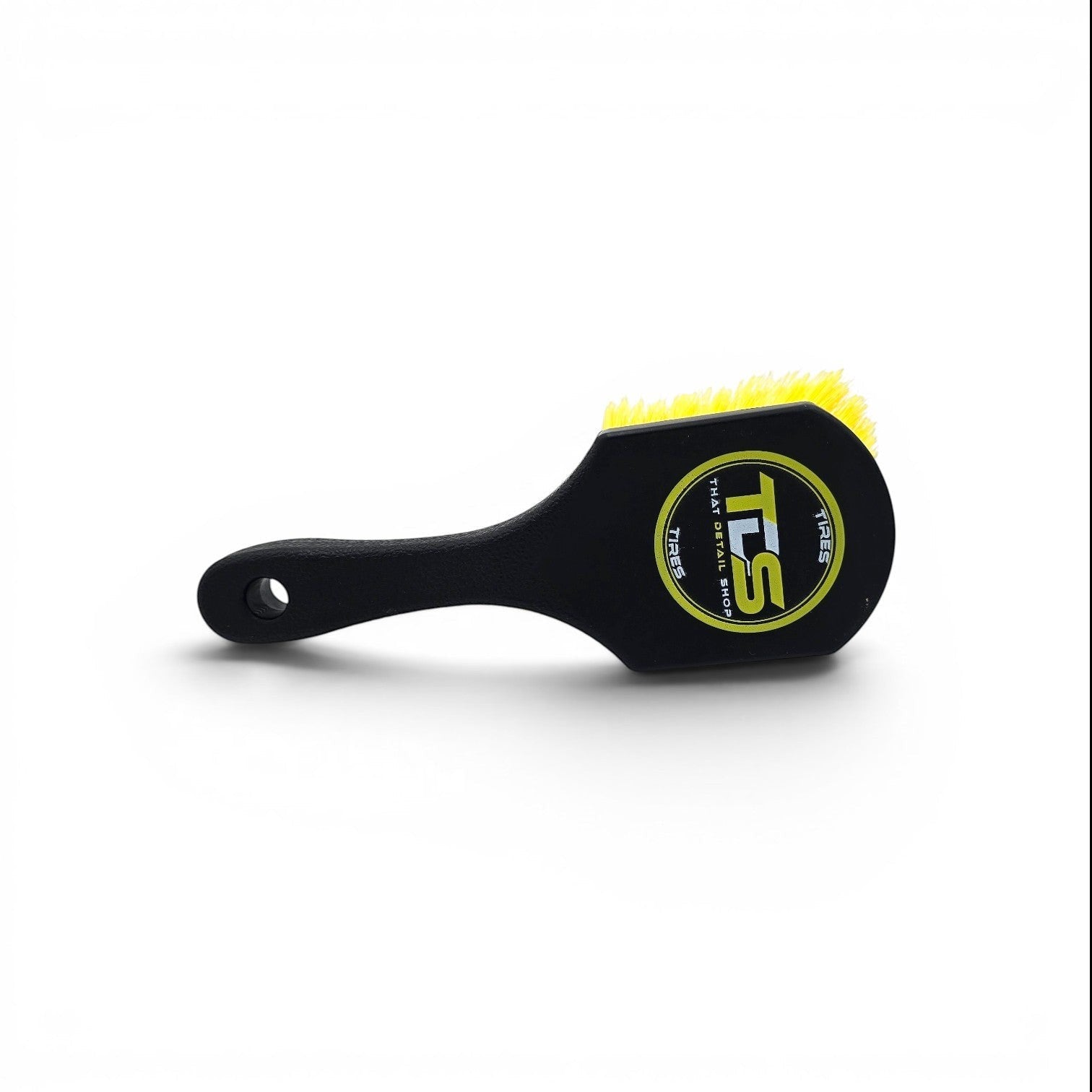 That Detail Shop black tire brush with yellow bristles and logo, designed for cleaning wheels and tires.