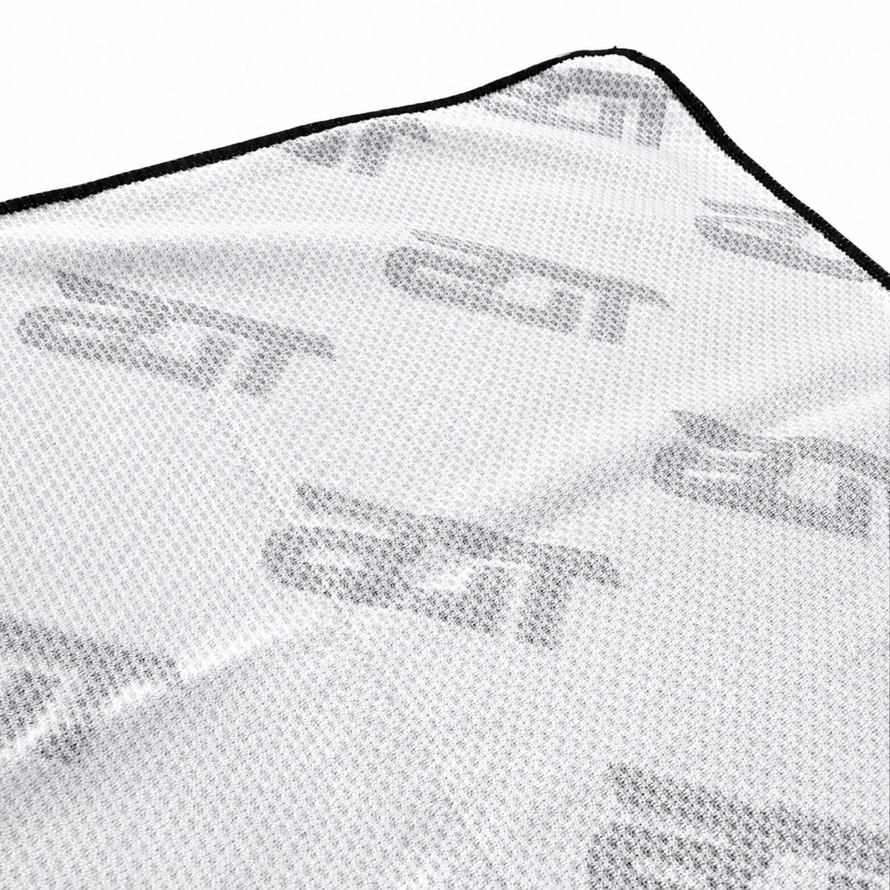That Detail Shop white lightweight Cooley cooling towel with a textured fabric pattern and black edge stitching.