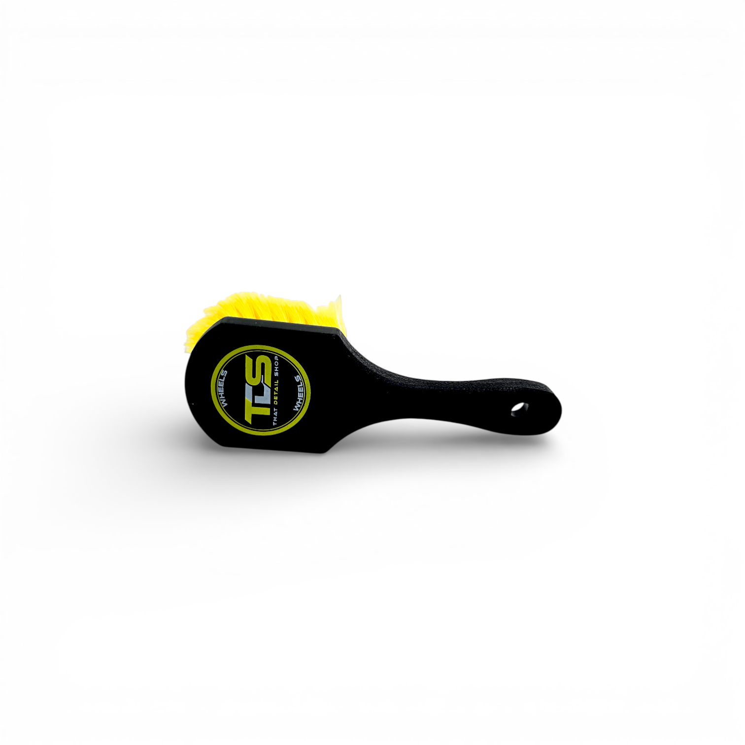 That Detail Shop black and yellow tire brush with stiff bristles and ergonomic handle for cleaning tire sidewalls.