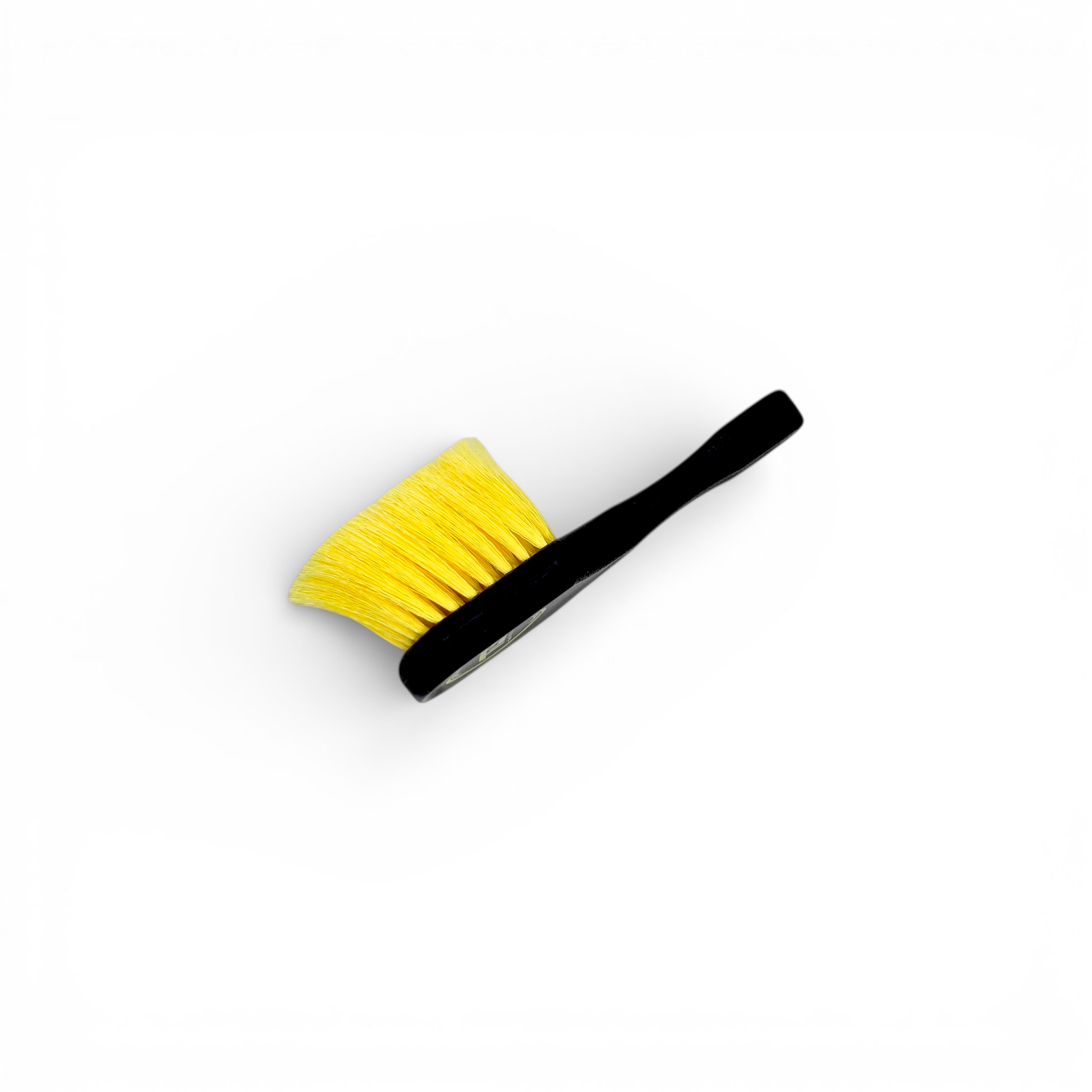 That Detail Shop black and yellow tire brush with stiff bristles and ergonomic handle for cleaning tire sidewalls.