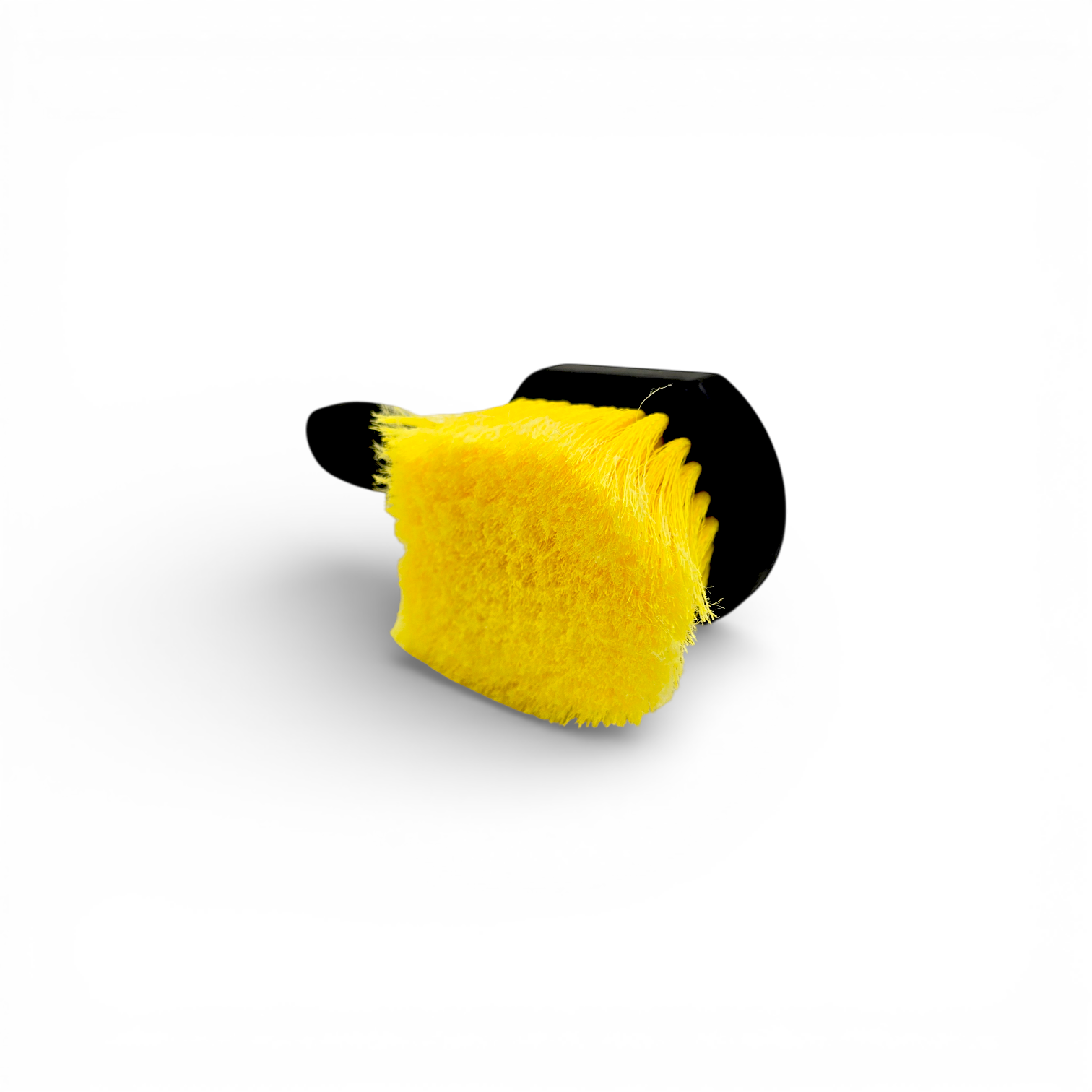 That Detail Shop black and yellow tire brush with stiff bristles for cleaning tire sidewalls.