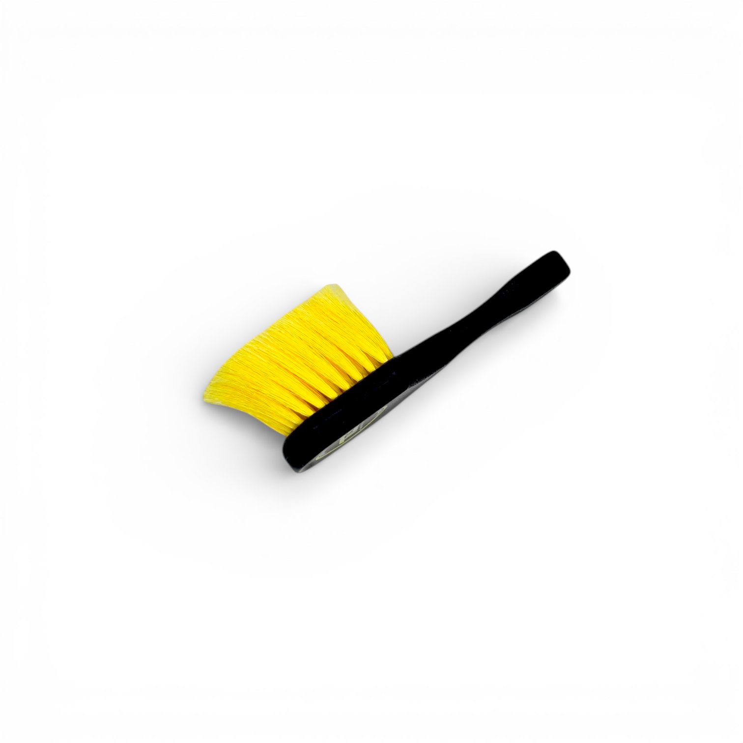 That Detail Shop black and yellow wheel brush with firm synthetic bristles for cleaning tight spokes and brake dust.
