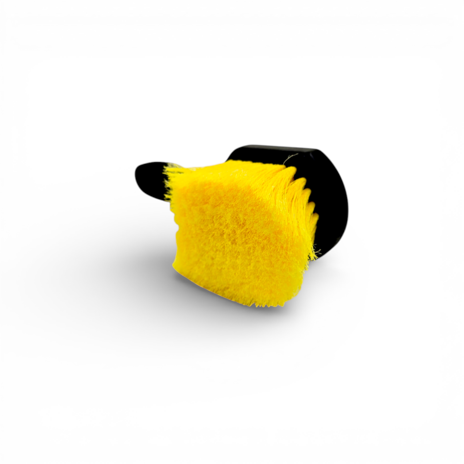 That Detail Shop black and yellow wheel brush with firm synthetic bristles for cleaning brake dust and grime.