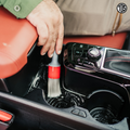 That Detail Shop interior detailing brush with soft bristles cleaning car console crevices and cup holders.